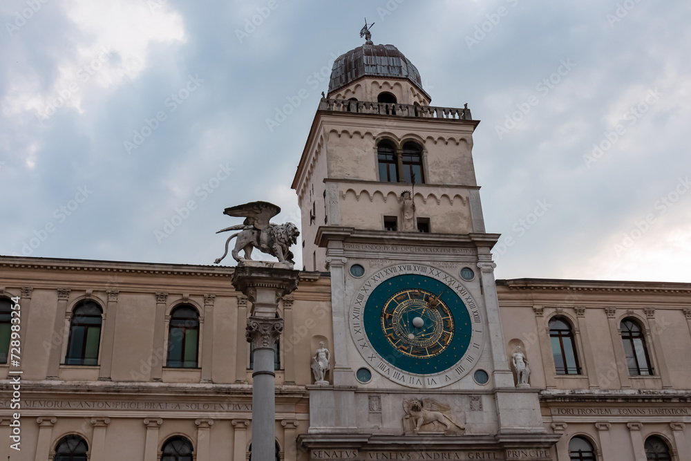 Scenic view on the astronomical clock on Piazza dei Signori in Padua, Veneto, Italy, Europe. Column of the winged lion statue of Saint Mark background Astronomical Clock. Central square in Padova