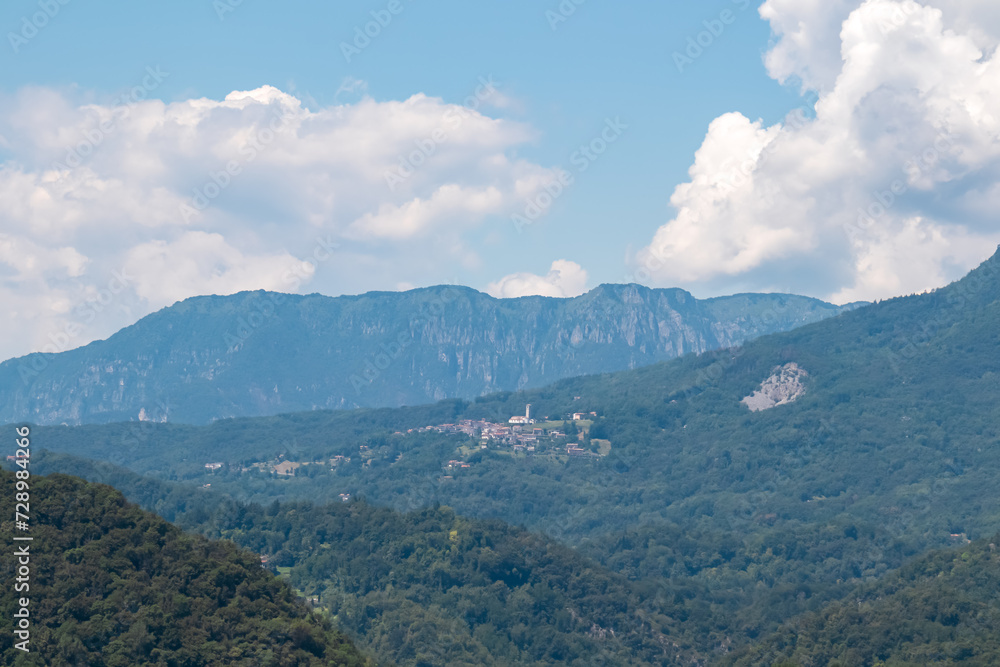 Scenic view of remote mountain village seen from Castle of Ragogna (Ruvigne) in Valeriano (Pinzano al Tagliamento), Friuli Venezia Giulia, Italy. Small town embedded in alpine hills in Italian alps