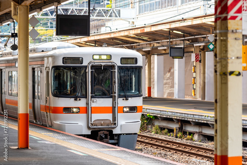 Local train arrive to railway station platform in Japan.