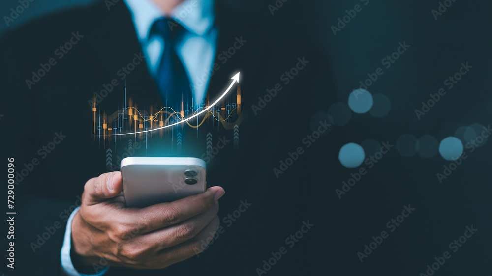 Investment and finance concept, businessman holding phone virtual trading graph. stock market, profits and business growth. Businessman showing a growing virtual hologram stock, invest in trading.