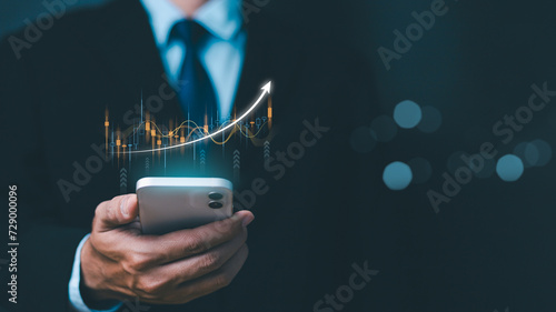 Investment and finance concept, businessman holding phone virtual trading graph. stock market, profits and business growth. Businessman showing a growing virtual hologram stock, invest in trading. photo