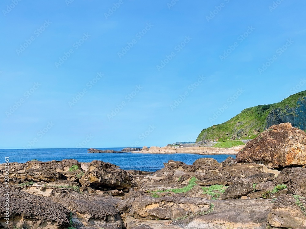 sea, beach, stone and rocks with blue sky