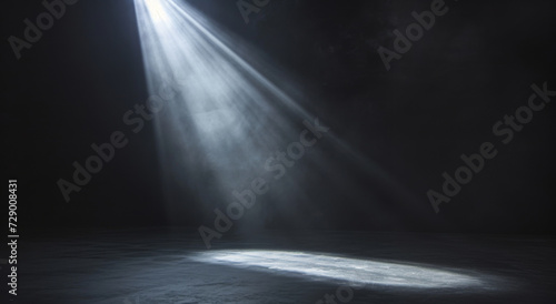 Spotlight shining down from an angle above onto a stage