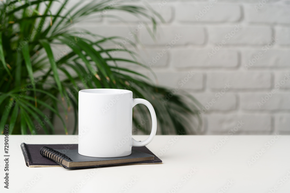 Coffee mug on table against brick wall Coffee mug on table against brick wall