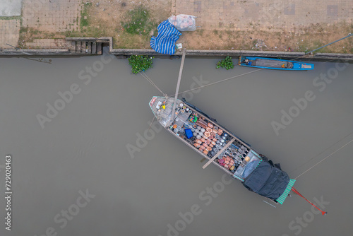 A boat filled with daily items prepares to dock for trading near the Vietnamese traditional Tet holiday in An Giang province. photo