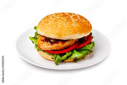 Burger, hamburger with chicken breast, tomato and lettuce on a plate. Isolated.