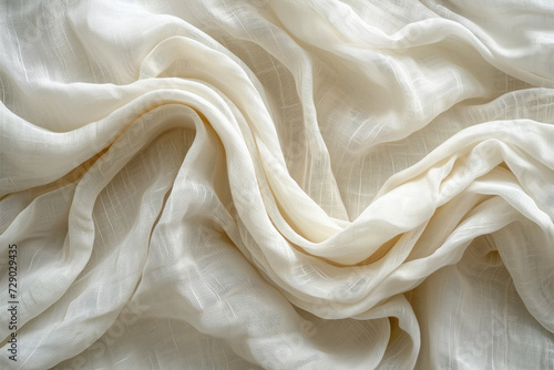 Elegant white gauzy fabric with delicate translucent texture gracefully draped, suitable for backgrounds or wedding design elements photo