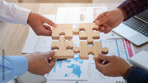 Concept of teamwork, cooperation and partnership. Business people connecting puzzle pieces in office. teamwork, Unity, volunteer, success and strategy. Business idea by merging jigsaw puzzle.