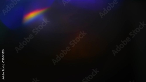Iridescent highlights, rainbow glare on a black background to overlay and create a bright, sunny and interesting picture, abstract background