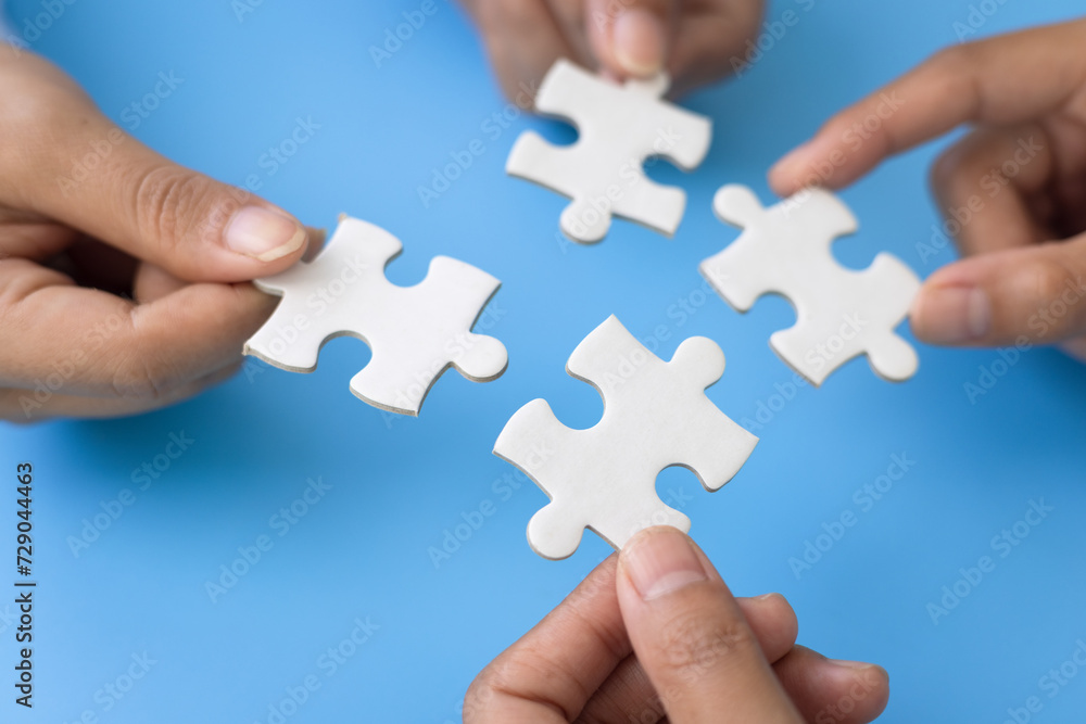 Hand put the last piece of jigsaw puzzle to complete the mission. Concept of connecting jigsaw pieces, problem solving, teamwork and success. Hand put the last piece of jigsaw puzzle to complete the mission. Concept of connecting jigsaw pieces, problem solving, teamwork and success.