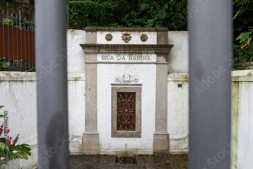 View to old historic Bica da Rainha water drinking fountain photo