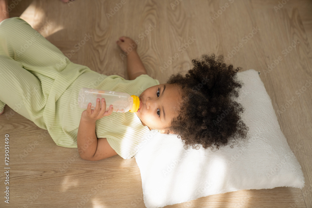 Little African American girl drinking milk and going to sleep at home. the child playing high-quality photo Little African American girl drinking milk and going to sleep at home. the child playing high-quality photo