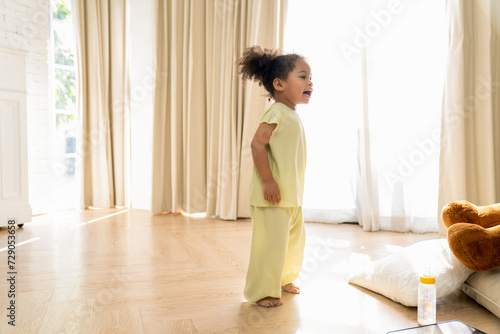 Wallpaper Mural Little African American girl playing freedom at home. the child playing high-quality photo Torontodigital.ca