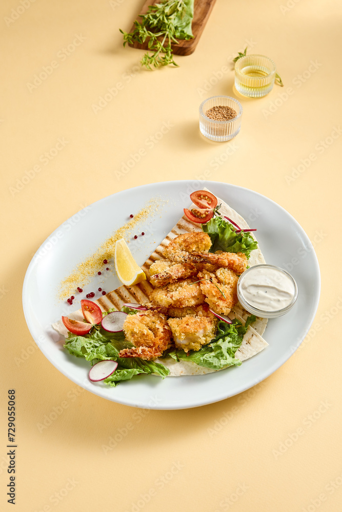 Tempura shrimp with tartar sauce on a bed of lettuce, presented on a white plate with lemon and tomato accents, against a soft yellow backdrop Tempura shrimp with tartar sauce on a bed of lettuce, presented on a white plate with lemon and tomato accents, against a soft yellow backdrop