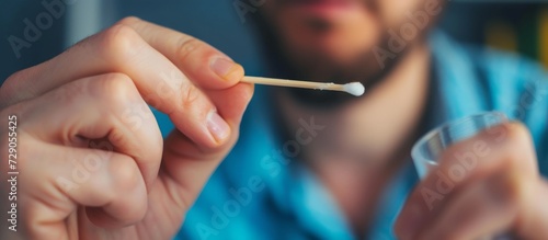 Man using home DNA test with cotton swab  specifically the BANNER  LONG FORMAT.