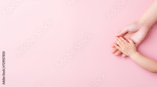 Wallpaper Mural Child's hand set against pink signifies the vitality of children's health. Torontodigital.ca