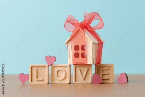 Gift of Love: Wooden House with Red Bow on Blocks Spelling LOVE