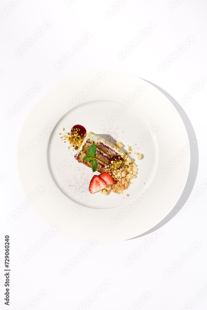 Pistachio cake with a raspberry layer and crumbled cookie-pistachio topping, isolated on a white background, top view Pistachio cake with a raspberry layer and crumbled cookie-pistachio topping, isolated on a white background, top view