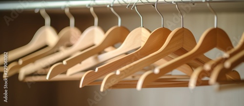 Empty wooden hangers on a closet rod, no clothes hung.