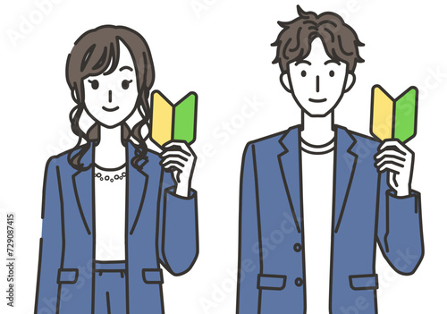 初心者マークを持つオフィスカジュアルコーデの女性と男性