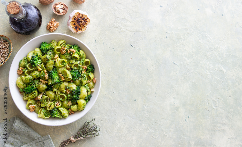 Pasta with broccoli, pesto sauce and nuts. Italian cuisine. Healthy eating. Pasta with broccoli, pesto sauce and nuts. Italian cuisine. Healthy eating.