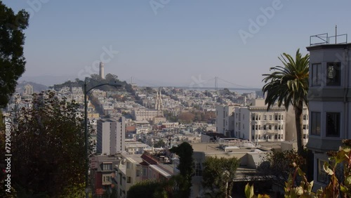 A View of Residences and Structures Along Lombard Street with Coit Tower in the Distance in San Francisco, California - Wide Shot