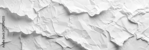 Crumpled paper texture, white and monochromatic, suitable for backgrounds or graphic design elements with a theme of recycling or complexity