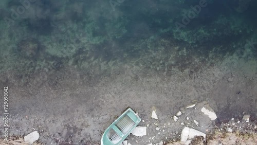 An aerial view of a small boat laying on the riverbed of river Adda in Lombardy, Italy  photo