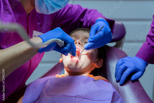 Dentist woman looking at a child's teeth at the dentist's office