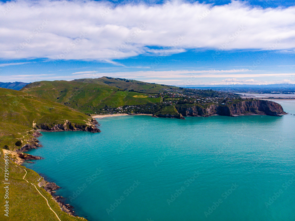 aerial panorama of godley heads near christchurch and lyttelton, canterbury, new zealand; turquoise water and large cliffs
