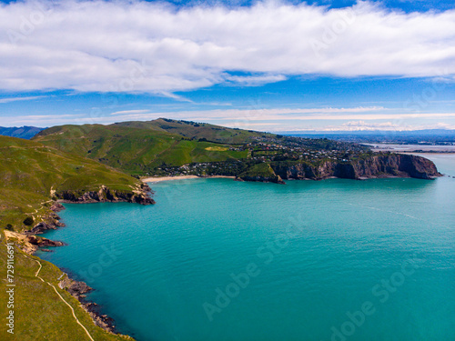 aerial panorama of godley heads near christchurch and lyttelton, canterbury, new zealand; turquoise water and large cliffs