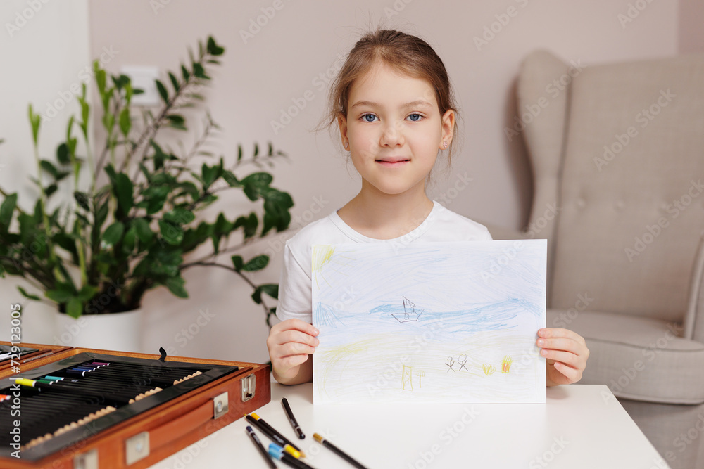 Little girl shows her painted picture