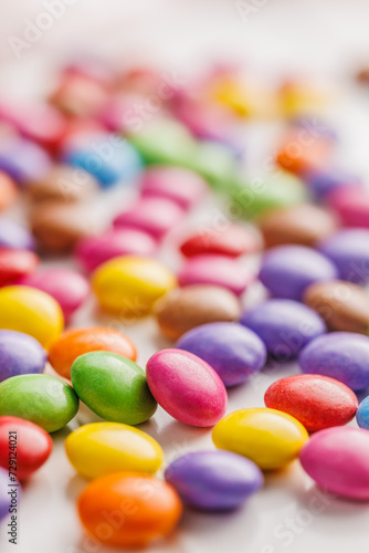 Colorful sweet candies on white table.