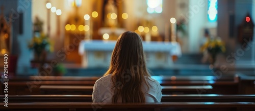 Christian woman praying at church altar, seeking guidance from spirituality.