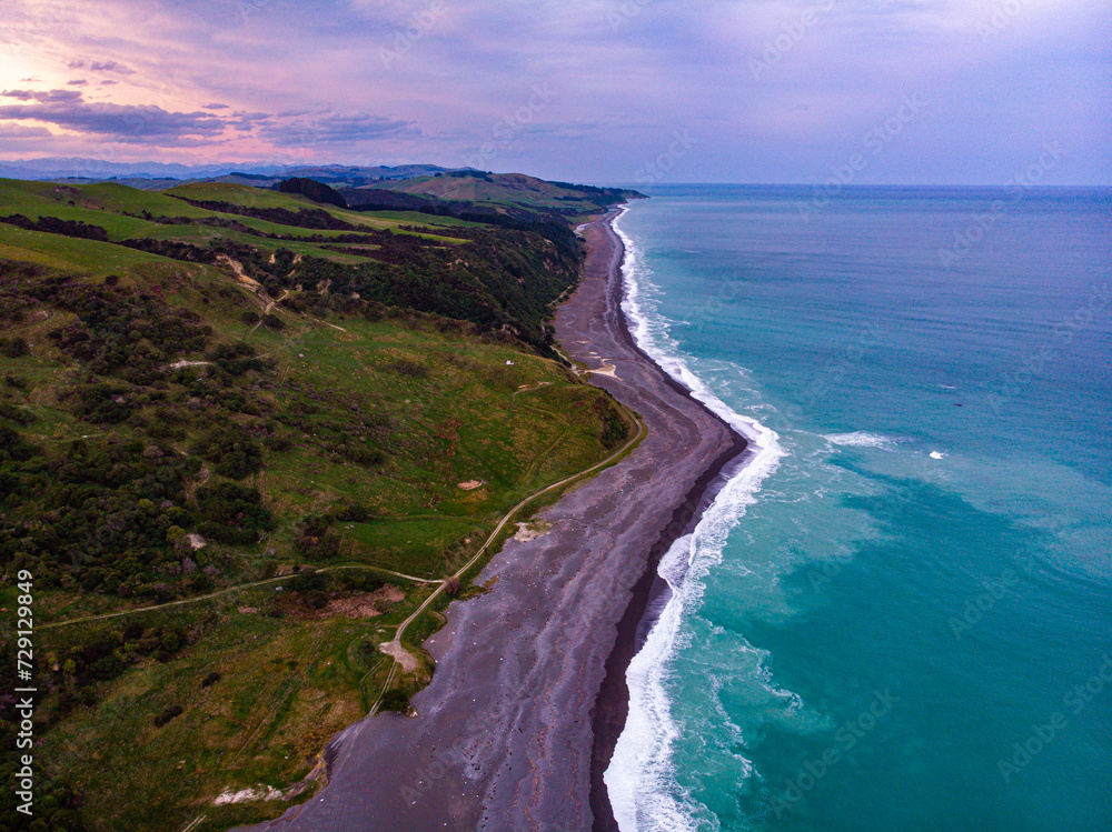 aerial panorama of beautiful nape nape beach in north canterbury, new zealand; black sand beach with turquoise water and large cliffs aerial panorama of beautiful nape nape beach in north canterbury, new zealand; black sand beach with turquoise water and large cliffs