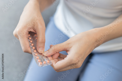Obraz na plátně Contraception and pregnancy concept asian young woman hand open birth control pi