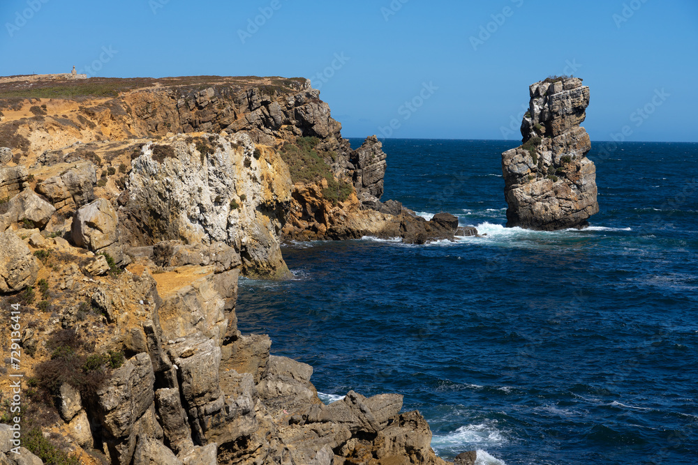 Rock formations of the Papoa island in the site of geological interest of the cliffs of the Peniche peninsula, portugal, in a sunny day.