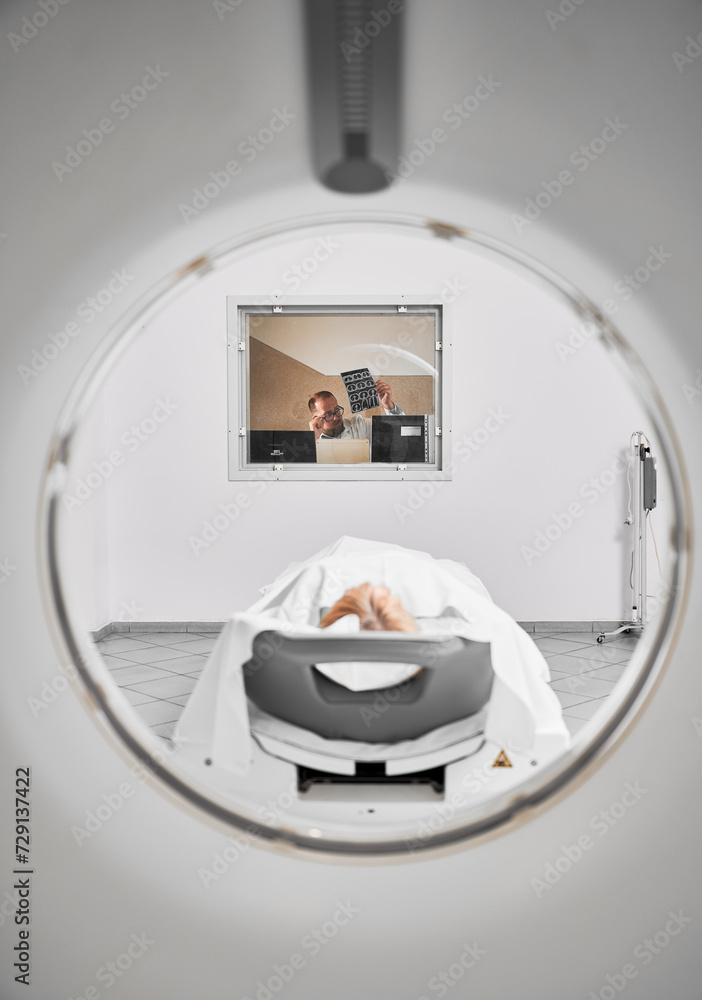 Medical computed tomography or MRI scanner. Doctor examining MRI ...