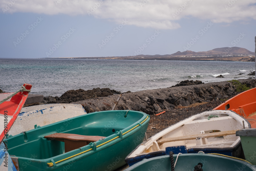 Fototapeta premium Stranded boats at the jetty in the village of Arrieta. Lanzarote, Canary Islands, Spain