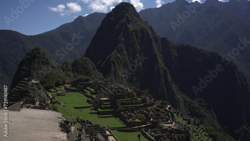 A stunning panoramic view of Machu Picchu, Peru, showcases the majestic mountains of Putucusi and Huayna, you can also see the buildings that the ancient Inca constructed with rectangular structures photo