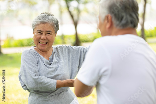 asian senior couple workout and practice tai chi in the park