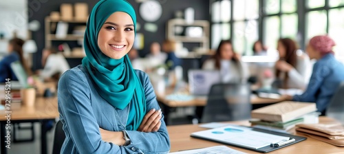 Confident and approachable hijab wearing professional woman in sleek office setting with copy space