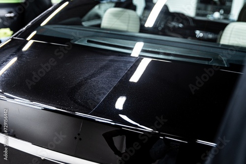 Obraz na płótnie Stunning glossy finish on a luxury car hood, showcasing meticulous detailing work and high-class care w salonie