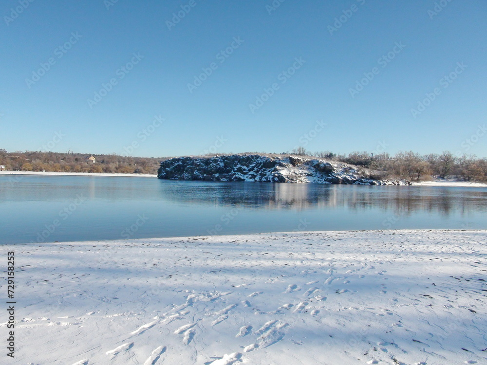 An unsurpassed view of the clear blue frosty sky above the snowy Baida archipelago surrounded by the frozen surface of the mighty Dnieper.