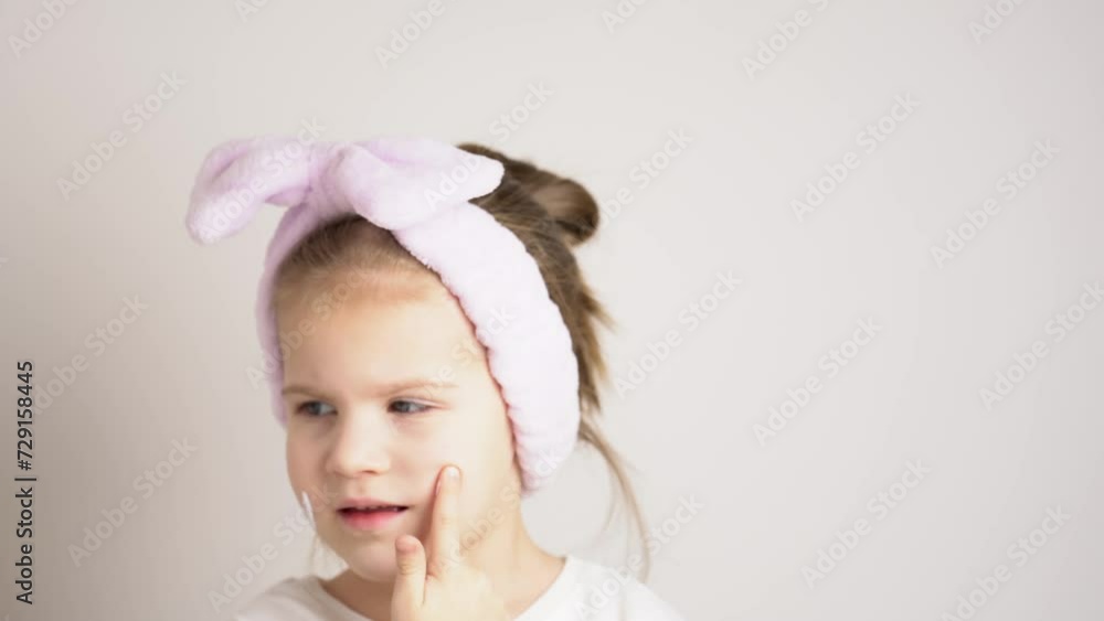 Little girl apply skincare cream on face, toddler girl put sunscreen on face. Kids skin care concept. Little girl apply skincare cream on face, toddler girl put sunscreen on face. Kids skin care concept.