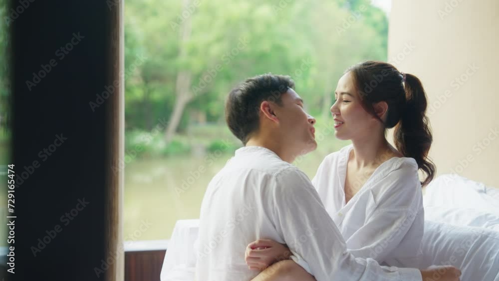 Young adult asia people happy lover flirt on cozy sofa bed hotel falling in love kiss hug beloved care trust. Sweet comfort asian lovers tender face to face man woman smile relax warm time date day. Young adult asia people happy lover flirt on cozy sofa bed hotel falling in love kiss hug beloved care trust. Sweet comfort asian lovers tender face to face man woman smile relax warm time date day.