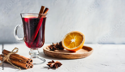 Mulled wine with spices and orange on a light background