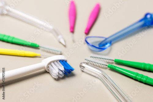 Toothbrush Oral Irrigator Floss Tongue Scraper Dental Brushes on beige Background Dental Cleaning Set Oral Hygiene Flat Lay Of Dental Care Tools Tooth Hygienic Equipment. Horizontal Plane