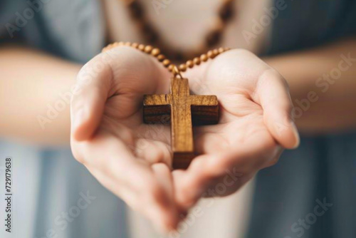Person Holding Wooden Cross in Hands