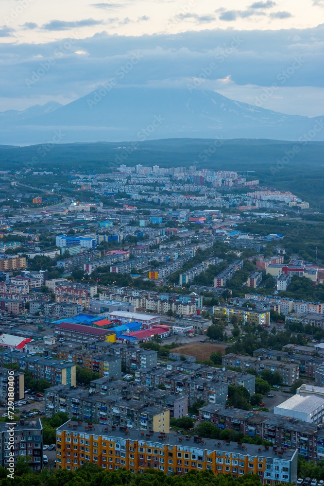 Morning cityscape. Top view of the buildings and streets of the city. Residential urban areas at twilight at dawn. A volcano in the distance. Petropavlovsk-Kamchatsky, Kamchatka, Far East of Russia.